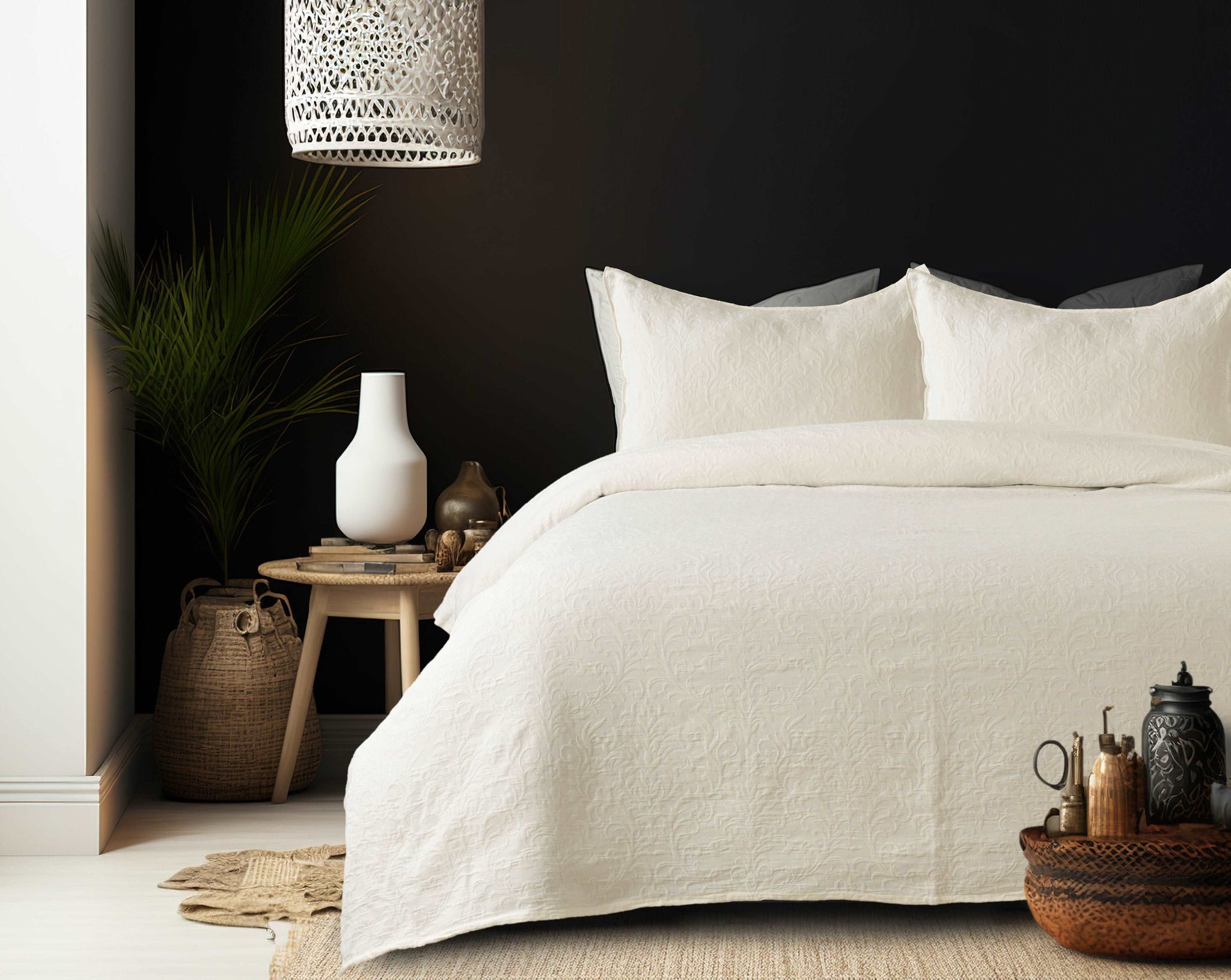 Cream-colored matelassé cotton bedcover with floral design on a queen-size bed. Includes two matching pillow shams.