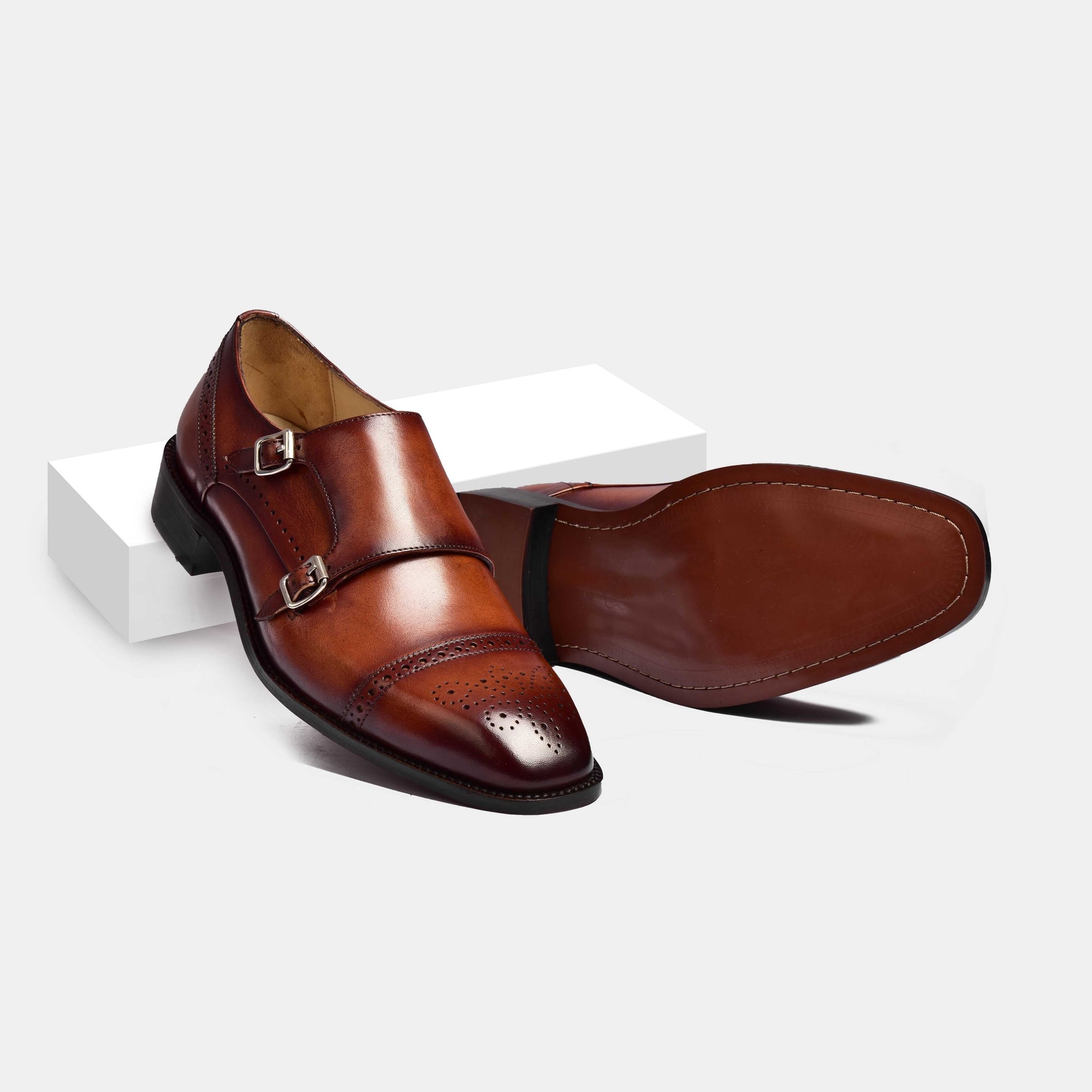 Pair of Henry Tan Double Leather Monk Straps in brown, showcasing the double buckle and brogue detailing.